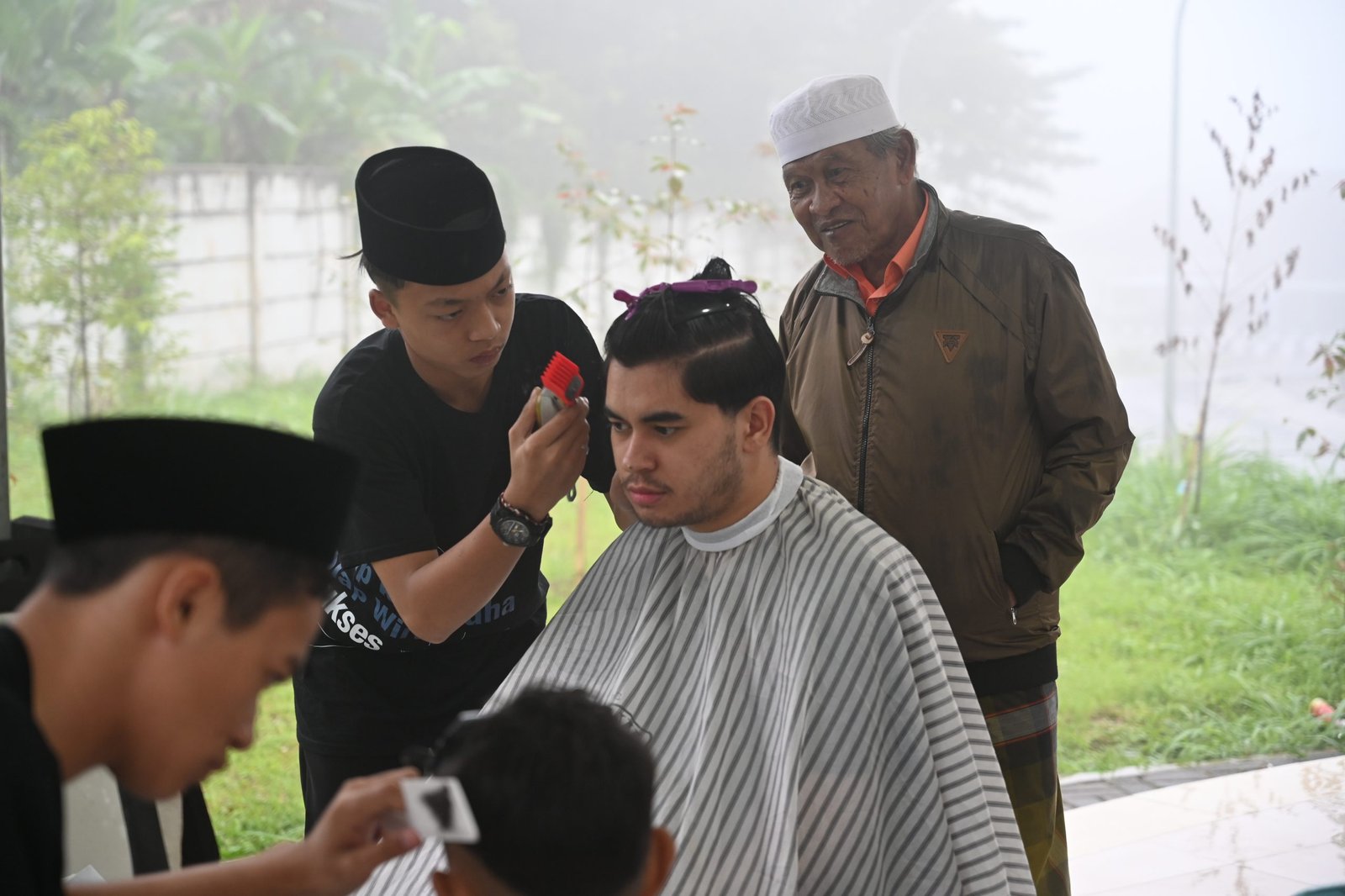 Layanan pangkas rambut oleh peserta pelatihan kepada masyarakat Cisarua, Bogor pada acara Goes to Public. Bogor, Ahad (19/01/2025).